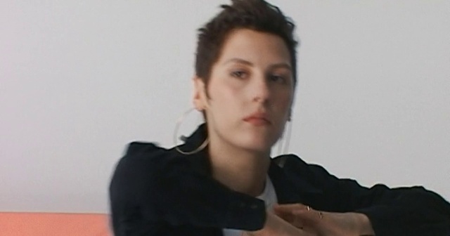 Video Reference: Outerwear, Eyelash, Jaw, Sleeve, Gesture, Flash photography, Thumb, Black hair, Audio equipment, Elbow