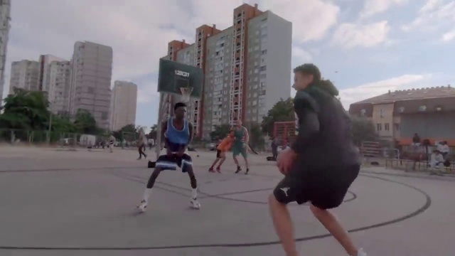 Video Reference: Sky, Cloud, Shorts, Building, Tree, Streetball, Sports equipment, Exercise, Asphalt, Leisure