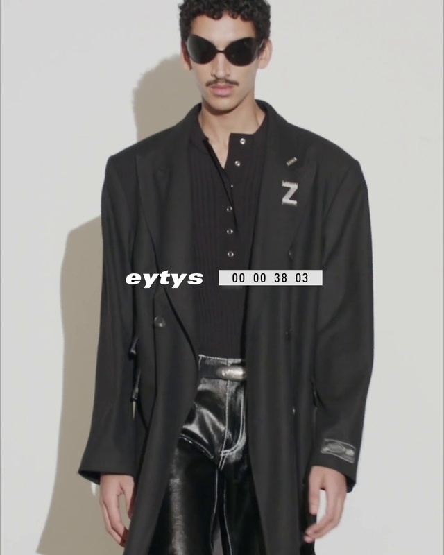 Video Reference: Face, Outerwear, Shoe, White, Black, Street fashion, Vision care, Neck, Sleeve, Waist