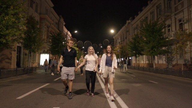 Video Reference: Building, Shorts, Leg, Window, Infrastructure, Road surface, Gesture, Tree, Public space, City