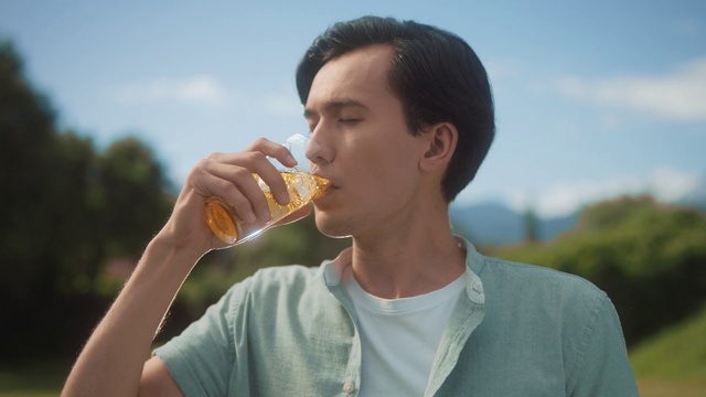 Video Reference: Sky, Hand, Food, Arm, Shirt, Cloud, Drinkware, Gesture, Happy, Drink