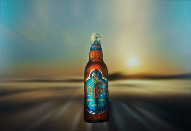 Video Reference: beer bottle, lager, tiger beer, product shot, drink, bottled beer, centered, sunset background, blurred background, commercial, advertising, beverage