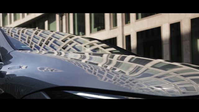 Video Reference: Hood, Automotive lighting, Automotive design, Automotive tire, Grille, Building, Motor vehicle, Rectangle, Vehicle door, Font