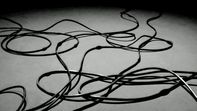 Video Reference: cables, wires, tangled, coiled, messy, electrical, cords, abstract, monochrome, floor, closeup