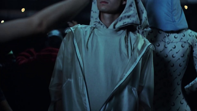 Video Reference: Sleeve, Flash photography, Event, Darkness, Fashion design, Entertainment, Raincoat, Room, Night, Performing arts