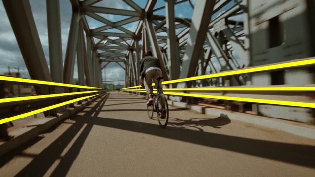 Video Reference: Bicycle, Sky, Road surface, Asphalt, Bicycle tire, Bicycle frame, Thoroughfare, Symmetry, Bridge, Road