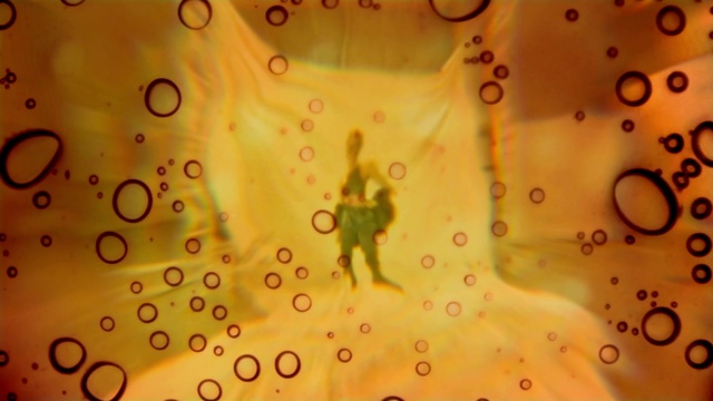 Video Reference: Liquid, Amber, Organism, Circle, Pattern, Font, Space, Art, Close-up, Macro photography