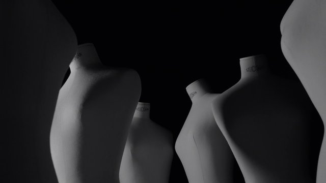 Video Reference: mannequins, dress forms, studio, fashion, sewing, tailoring, silhouette, black background, minimalist, still life, abstract, design
