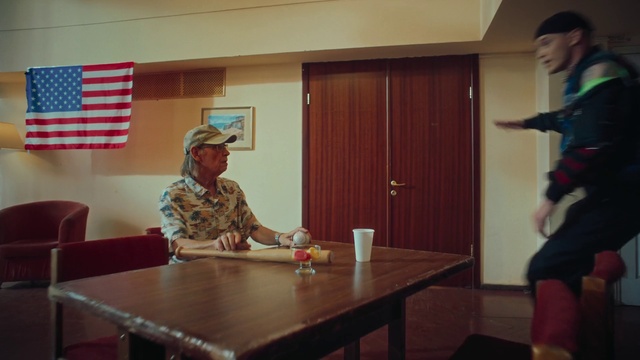 Video Reference: Table, Furniture, Tableware, Chair, Flag of the united states, Wood, Flag, Military person, Shorts, Door