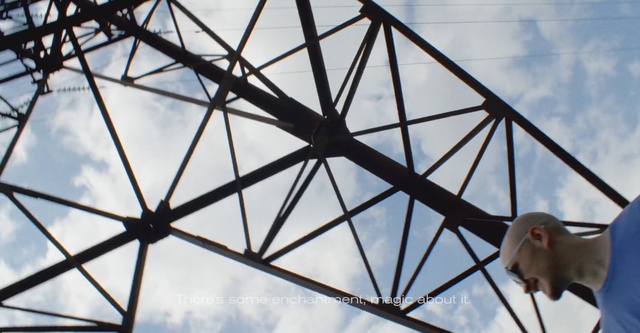 Video Reference: Cloud, Sky, Daytime, Triangle, Electricity, Tints and shades, Overhead power line, Symmetry, Roof, Public utility