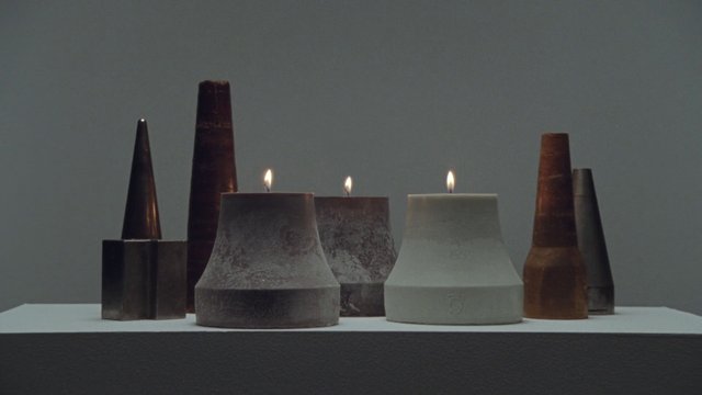 Video Reference: candles, still life, minimalist, product shot, wax, lit candles, abstract shapes, gray background, tabletop, decor, home decor, studio lighting, symmetry, close-up