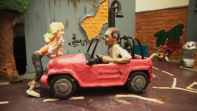 Video Reference: stop-motion, clay animation, handmade, miniature, red car, alley, graffiti, brick wall, figurines, art installation, urban scene, animation frame