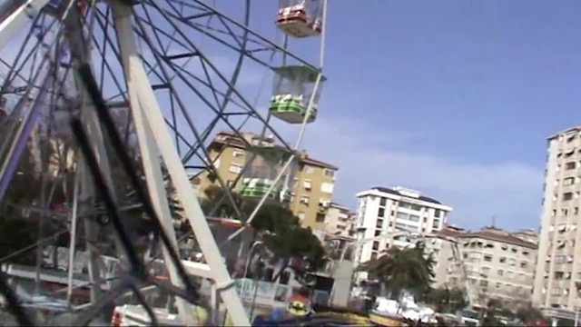 Video Reference: Sky, Building, Ferris wheel, Cloud, Urban design, Travel, City, Engineering, Leisure, Automotive wheel system