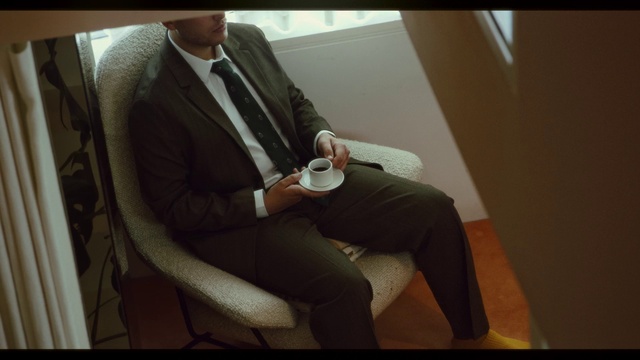 Video Reference: Suit trousers, Comfort, Sleeve, Eyewear, Tie, Collar, Automotive design, Knee, Suit, Thigh