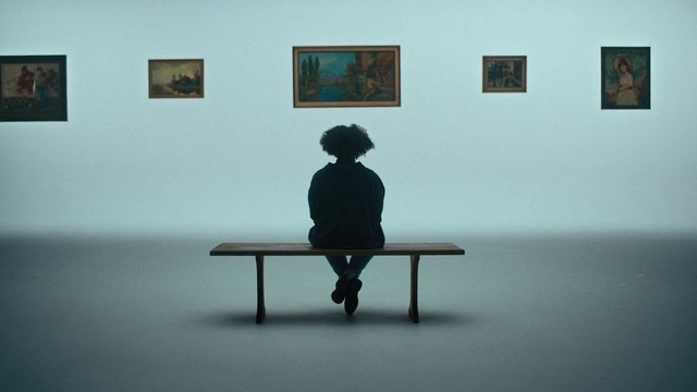 Video Reference: Furniture, Picture frame, Human body, Standing, Art, Grey, Table, Floor, Wall, Bench