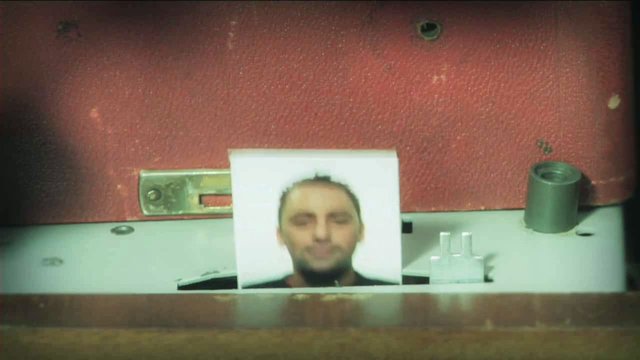 Video Reference: portrait, printed photo, man, machine, panel, industrial, close-up, blurry, paper, equipment, indoor, still life