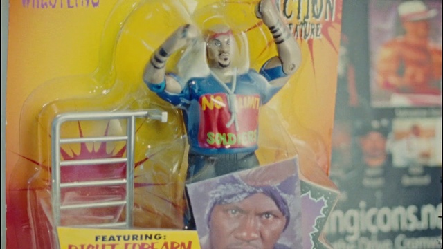 Video Reference: Product, Toy, Yellow, Doll, Publication, Font, Plastic, Art, Fictional character, Action figure