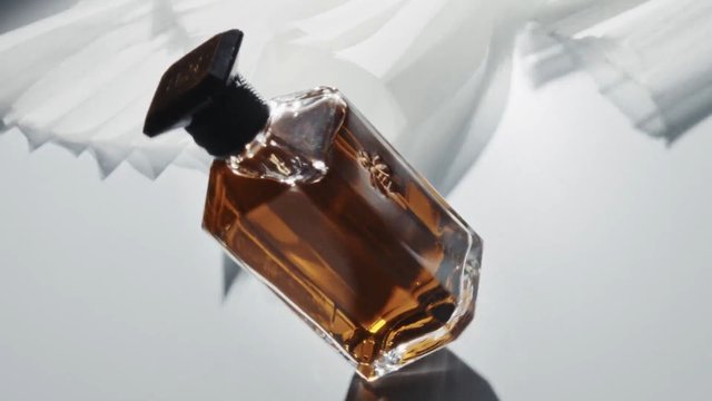 Video Reference: perfume, fragrance, bottle, glass, amber, luxury, cosmetic, product, close-up, still life, elegant, reflective, packaging