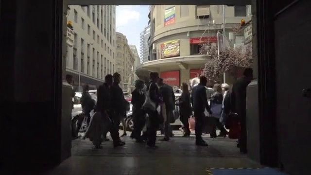 Video Reference: Building, Tire, Window, Wheel, Road, City, Sidewalk, Event, Pedestrian, Sky