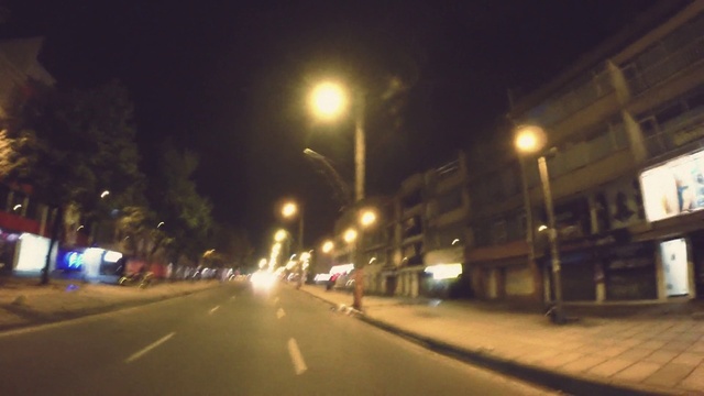 Video Reference: Street light, Automotive lighting, Road surface, Sky, Electricity, Asphalt, Building, Thoroughfare, Window, Headlamp