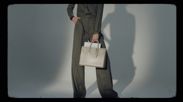 Video Reference: Bag, Sleeve, Waist, Knee, Luggage and bags, Fashion design, Gadget, Blazer, Formal wear, Thigh