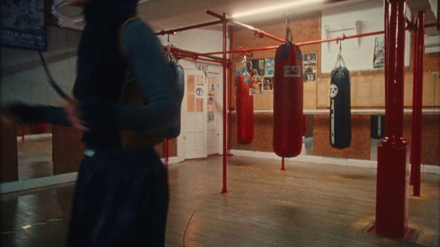 Video Reference: Punching bag, Sports equipment, Flooring, Recreation, Sportswear, Event, Physical fitness, Sport venue, Contact sport, Boxing