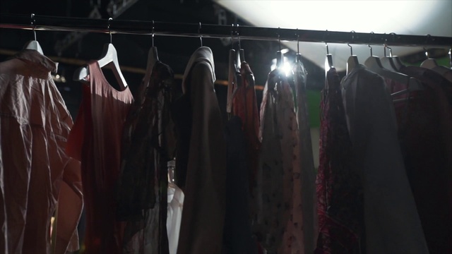 Video Reference: Sleeve, Tints and shades, Clothes hanger, Event, Fashion design, Retail, Room, Darkness, T-shirt, City