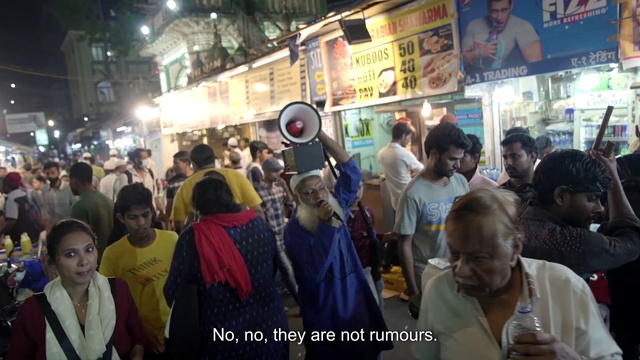 Video Reference: Temple, Building, Crowd, Hat, Public space, City, Event, Market, T-shirt, Fun