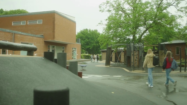 Video Reference: Property, Sky, Building, Road surface, Shade, Tree, Asphalt, Urban design, Residential area, Road