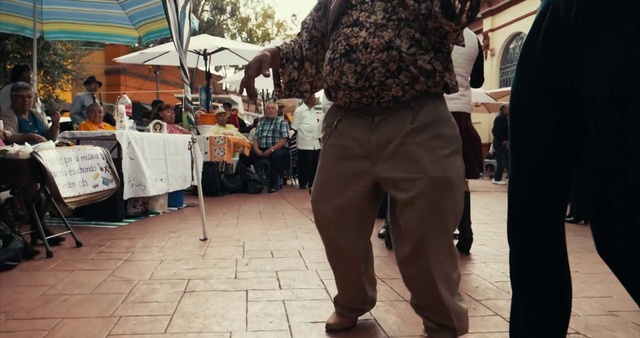Video Reference: Shoe, Tent, Waist, Street fashion, Umbrella, Performing arts, Crowd, City, Thigh, Sunglasses