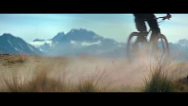 Video Reference: Bicycle, Sky, Wheel, Atmosphere, Bicycle tire, Tire, Bicycle handlebar, Natural landscape, Mountain, Sunlight