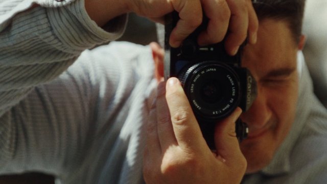 Video Reference: camera, photography, close-up, person, hands, lens, portrait, selfie, viewfinder, indoor, focus, shallow depth of field
