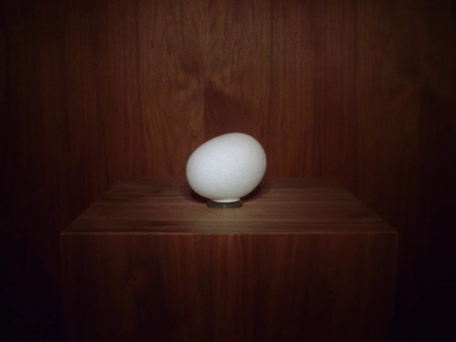 Video Reference: Egg, Table, Wood, Serveware, Hardwood, Egg, Plywood, Darkness, Light fixture, Ball