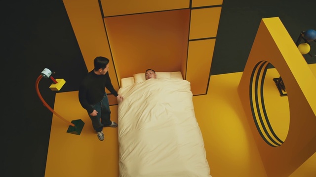 Video Reference: Comfort, Automotive design, Orange, Floor, Flooring, T-shirt, Font, Room, Bed frame, Ceiling