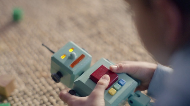 Video Reference: Hand, Green, Toy, Finger, Nail, Electric blue, Technology, Thumb, Plastic, Lego