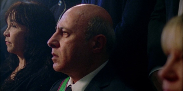 Video Reference: Forehead, Nose, Chin, Mouth, Suit, Spokesperson, Event, Audio equipment, Fun, Formal wear