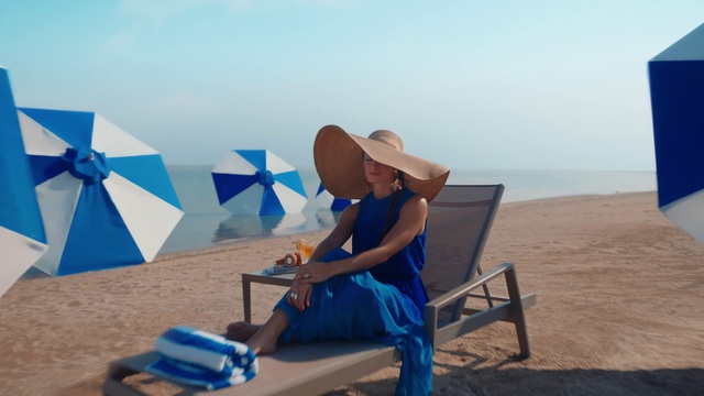 Video Reference: Sky, Hat, Travel, People on beach, Outdoor furniture, Sun hat, Leisure, Beach, Horizon, Fun