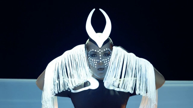 Video Reference: Sleeve, Gesture, T-shirt, Performing arts, Event, Mask, Fictional character, Personal protective equipment, Entertainment, Costume design