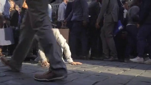 Video Reference: Gesture, Road surface, Blazer, Thigh, Suit, Formal wear, Asphalt, Human leg, Road, Event