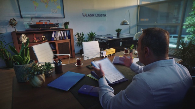 Video Reference: Plant, Furniture, Houseplant, Flowerpot, Coat, Table, Bookcase, Picture frame, Suit, Engineering