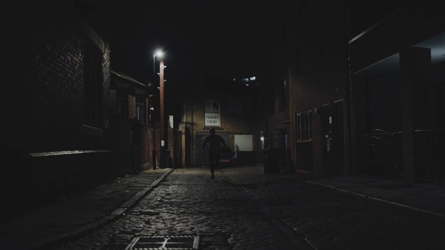 Video Reference: Atmosphere, Automotive lighting, Road surface, Street light, Building, Black-and-white, Grey, Asphalt, Flash photography, Electricity