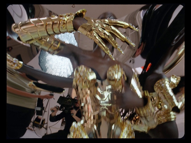 Video Reference: Automotive lighting, Gold, Art, Metal, Fashion accessory, Font, Event, Ceiling, Chandelier, Glass