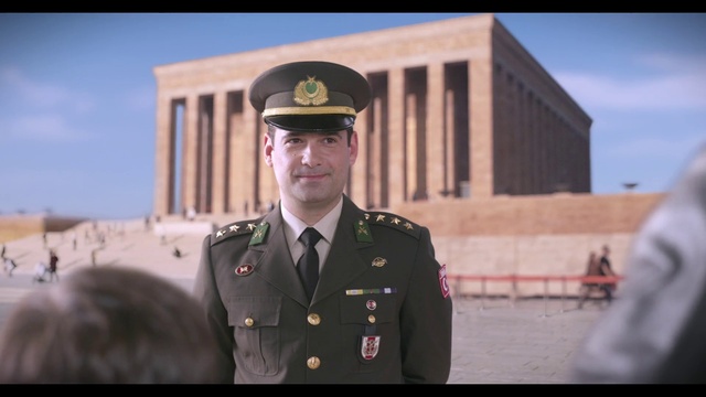 Video Reference: Sky, Smile, Military uniform, Security, Military person, Dress shirt, Gesture, Building, Soldier, Non-commissioned officer
