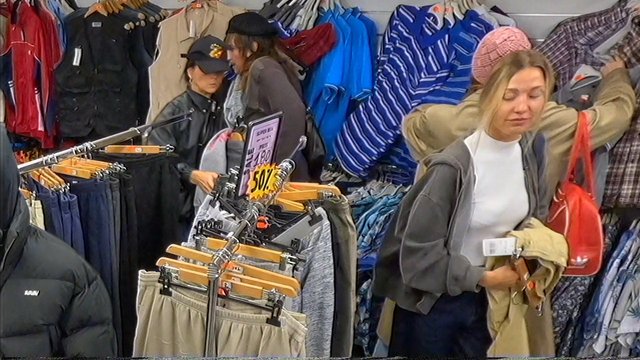 Video Reference: clothing store, shopping, retail, women, clothes rack, sale, jackets, shirts, pants, browse, indoor, fashion, store aisle, merchandise