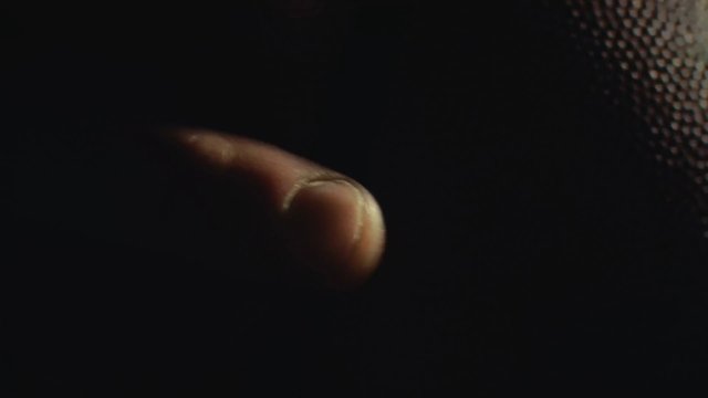 Video Reference: fingertip, close-up, macro, dark background, texture, human skin, abstract, low light, detail, isolated