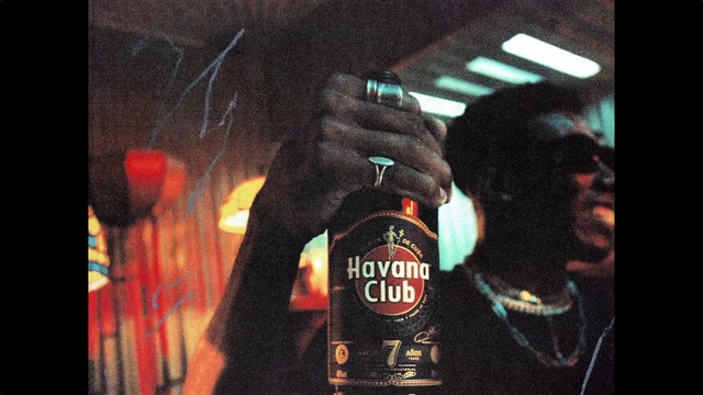 Video Reference: Sleeve, Bottle, Glass bottle, Drink, Alcoholic beverage, Font, Beer, Alcohol, Distilled beverage, Darkness