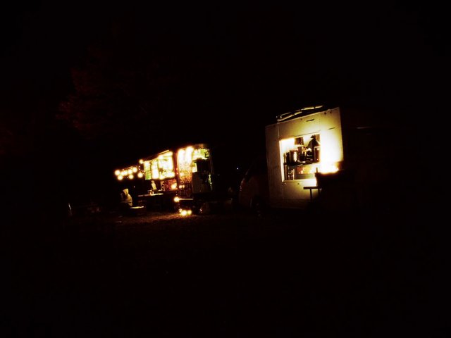 Video Reference: night, food truck, street food, mobile stall, outdoor, string lights, dark, festival, vendor, truck, catering, night market, warm lights, silhouette