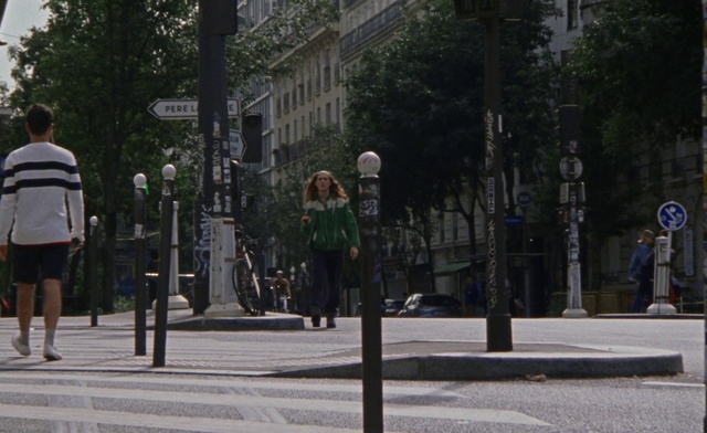 Video Reference: Shorts, Building, Road surface, Traffic light, Tree, Urban design, Sidewalk, Thoroughfare, signaling device, Road