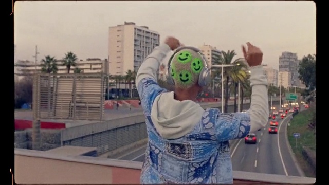 Video Reference: Building, Sky, Vehicle, Car, Asphalt, City, Urban area, Personal protective equipment, Tree, Road