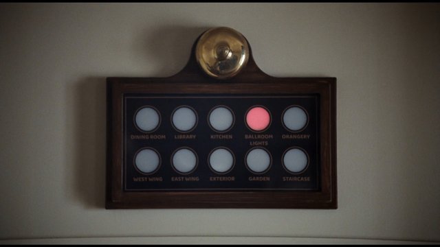 Video Reference: control panel, wall panel, buttons, indicator lights, interior, room labels, wooden frame, house controls, lighting, hallway, mansion, switch panel